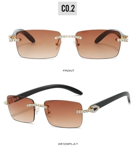 Detail of rimless sunglasses featuring gradient brown lenses and diamond-set C-hinges