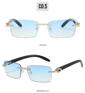 Detail of rimless rectangle sunglasses with blue gradient lenses and gold diamond accents
