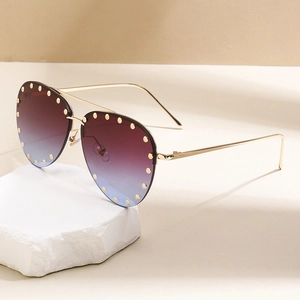Chic aviator sunglasses with gradient lenses and gold rivet studs on metal frame