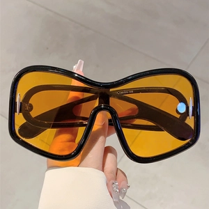 Detail of high-quality black frame Y2K sunglasses with transparent yellow lens and inner code