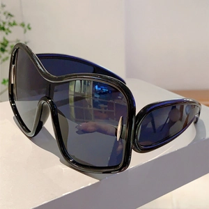 Detail view of Y2K futuristic oversized sunglasses with silver metal side accents