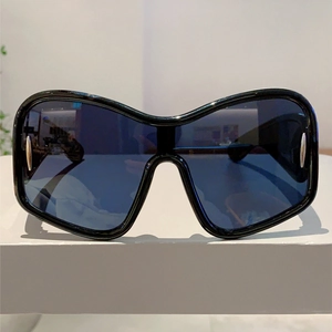 Detailed front view of Y2K futuristic oversized sunglasses with silver metal accents