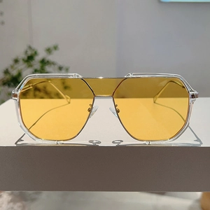 Macro view of oversized square sunglasses with yellow lenses and clear frames