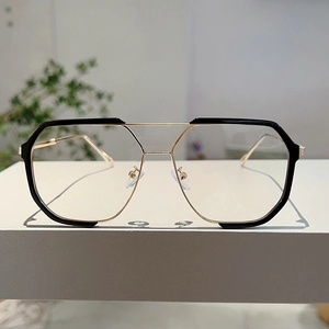 Detail of fashion oversized gold and black polygon sunglasses with double bridge design