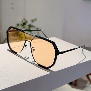 Detail of vintage aviator sunglasses with orange lenses and double bridge black frame