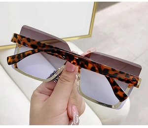 Detail of rimless square sunglasses with gradient purple lenses and leopard print temples