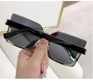 Detail of rimless square sunglasses with gold metal trim and black temples for women