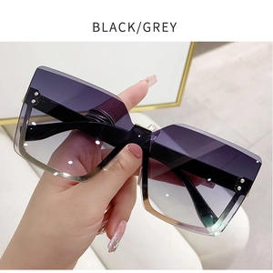Detail of rimless square sunglasses with grey gradient lenses and silver screw accents
