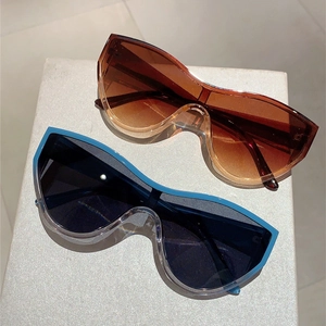 Close-up of brown and blue oversized shield sunglasses with a modern gradient lens