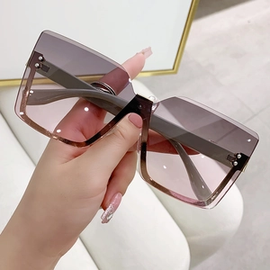 Frameless oversized square gradient sunglasses with gold metal accents and silver rivets