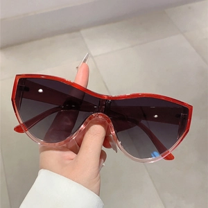 Detail of red translucent cat-eye sunglasses with gradient UV protection lenses