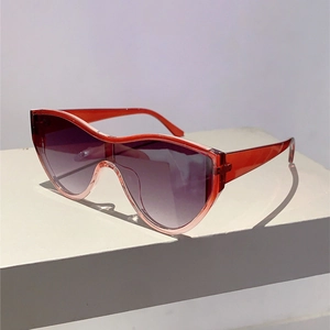 Detail of oversized shield sunglasses with wavy red frame and purple gradient lenses