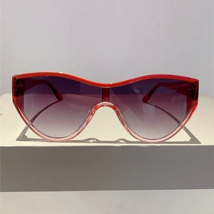 Detail of red-pink gradient oversized frame and sleek gradient lenses for sunglasses