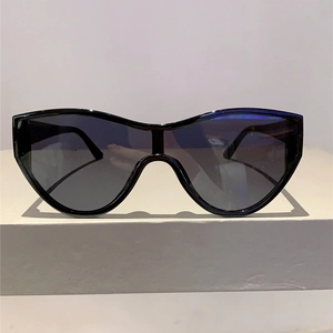 Macro view of black oversized one-piece wrap sunglasses with sleek cat-eye frame design