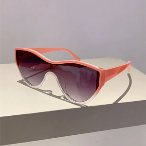 Detail of coral pink and transparent oversized sunglasses with gradient lenses