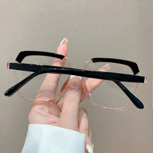 Detail view of stylish two-tone large frame glasses in black and transparent pink finish