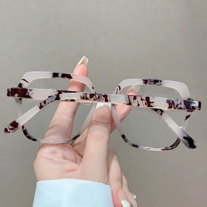 Macro detail of geometric polygon eyewear frame with black and white tortoiseshell texture