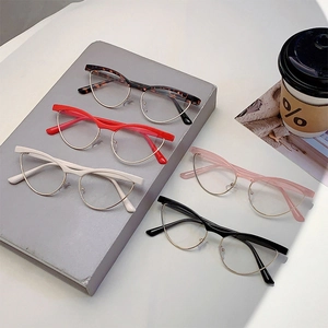 Collection of retro cat-eye anti-blue light glasses in five colors on a desktop set