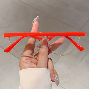 Detail of red cat-eye frame and gold metal rim on these stylish anti-blue light glasses