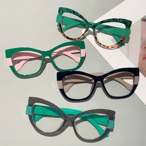 Macro shot of stylish cat-eye glasses frames in four color combinations arranged on a magazine