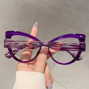 Detail of purple cat eye glasses frame with stylish striped temples and polished finish