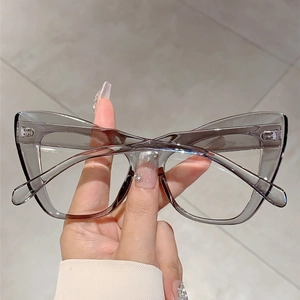 Detail shot of translucent gray cat-eye glasses frame with premium metal hinges