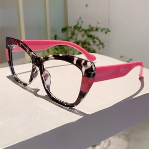 Close-up of cat-eye glasses with black and white tortoiseshell frames and pink temples