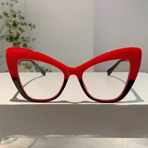 Detail of retro cat eye glasses showing unique red and black color block frame design