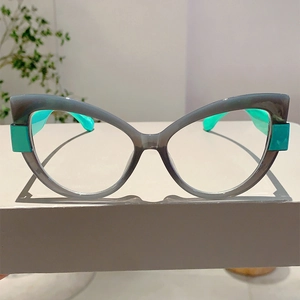 Detail view of cat-eye glasses frame in transparent grey and vibrant green accents