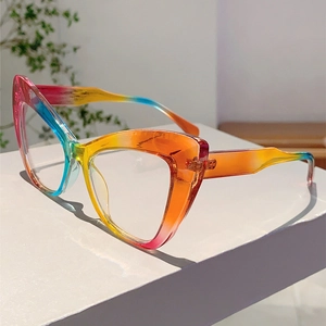 Detail view of rainbow gradient cat-eye glasses frame on a white geometric stand