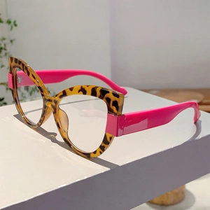 Detail of stylish leopard print cat-eye frame and vibrant pink temples on glasses