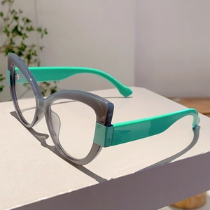 Detail view of cat eye glasses frame showing grey finish and turquoise green temples