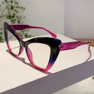 Close-up of cat-eye glasses with black to purple gradient frames on a white stand