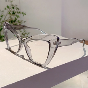 Detail of transparent cat-eye glasses showing the wide temple design and metal hinge