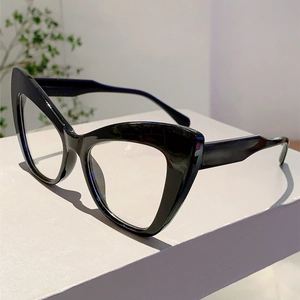 Close-up of retro cat-eye glasses with glossy black frames and clear optical lenses
