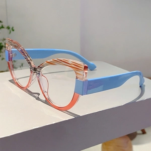 Detail of cat-eye glasses with zebra pattern top and blue arms on a display stand
