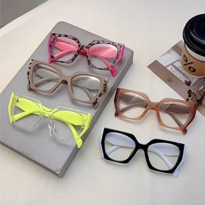 Neon geometric anti-blue light glasses frames in assorted colors on display stand
