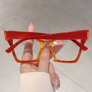 Macro detail of oversized cat eye glasses frame with red and orange gradient finish