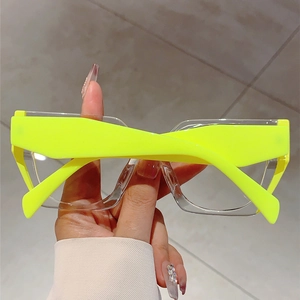Detail of neon green temples on oversized transparent square anti-blue light glasses