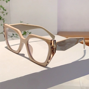 Detail of nude geometric glasses frame with gray marble textured temples on a stand