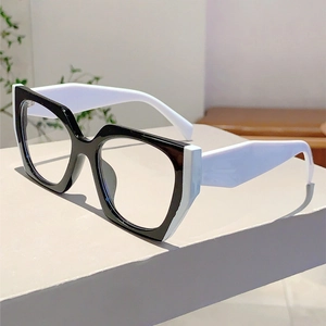 Detail shot of black and white geometric cat-eye glasses frame on minimalist display stand