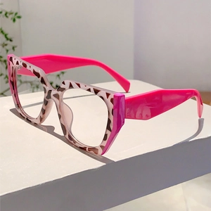 Detail of leopard print frames with vibrant hot pink temples on stylish eyeglasses