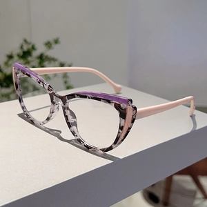 Detailed view of cat-eye frames with marble texture and purple accents on a gray surface