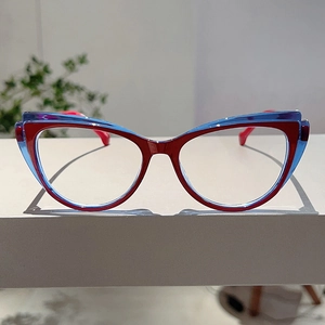 Detail view of cat eye glasses frame with red and blue splicing translucent design