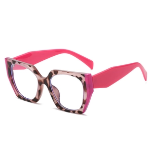 Retro tortoise polygon glasses frame with vibrant neon pink temples in a 45-degree angle view