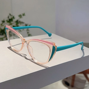 Detail of cat-eye glasses frame featuring clear pink resin and vibrant blue temples