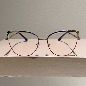 Detail of blue and gold cat-eye glasses frame with adjustable silicone nose pads