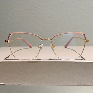 Close-up of rose gold cat-eye glasses frame with pink accents and anti-blue light lenses
