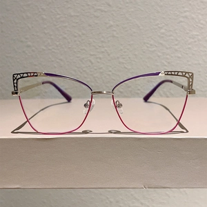 Detail of cat-eye metal glasses frame with purple gradient and hollow pattern