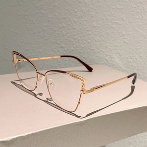 Detailed side view of cat-eye glasses frame with hollow geometric metal pattern